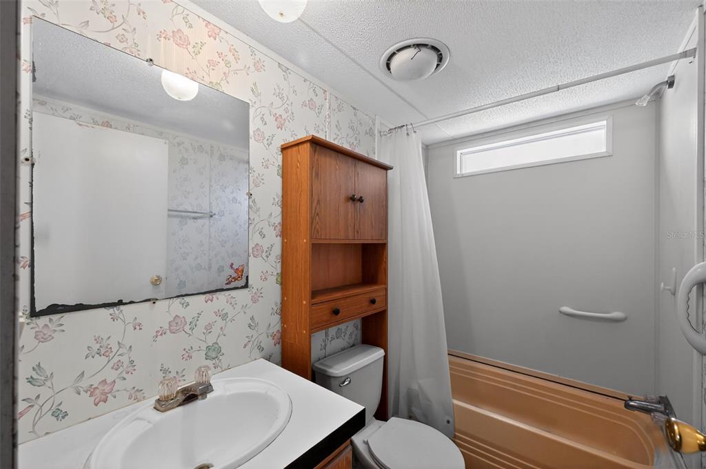 7405 Bonnie Lake Road Brooksville, FL 34601 - Photo 8 of 14 a bathroom with a sink and a mirror