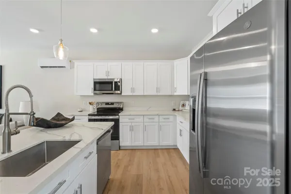 a kitchen with a sink stainless steel appliances and cabinets