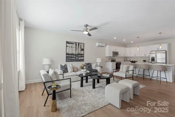 a living room with furniture dining table and a window