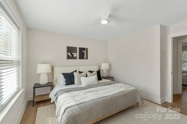 a bedroom with a bed and a large window