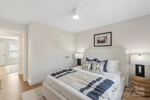 a bedroom with bed and wooden floor