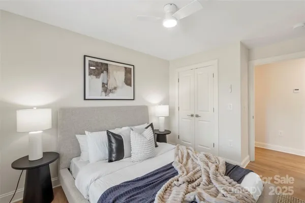a bedroom with a bed and a lamp