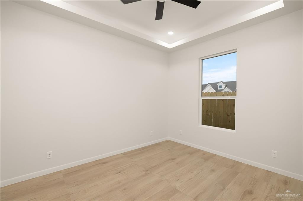 1107 Benjamin Street Mission, TX 78573 - Photo 15 of 19 Spacious room featuring wood-finish flooring, a contemporary ceiling fan, and recessed lighting