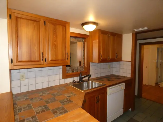 a kitchen with a sink and cabinets