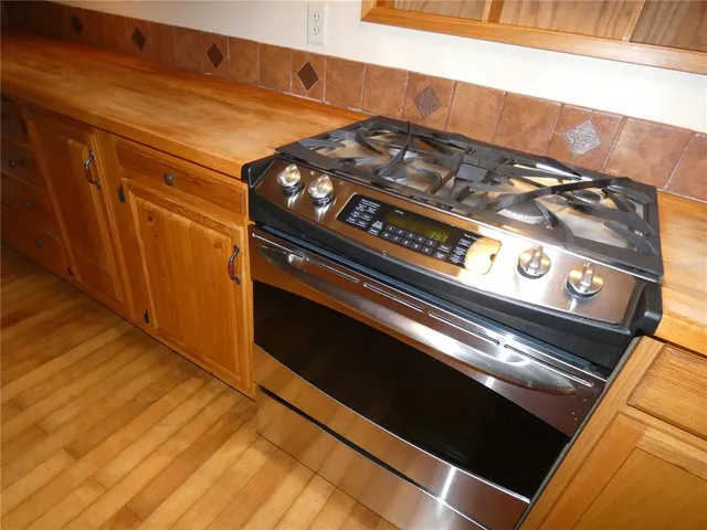 a bedroom with a bed and a refrigerator