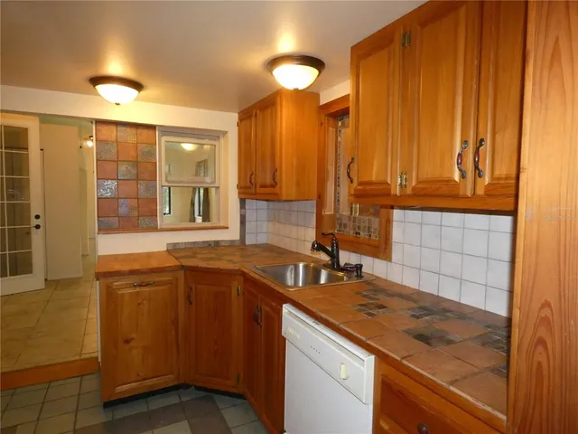 a kitchen with granite countertop a stove and a refrigerator