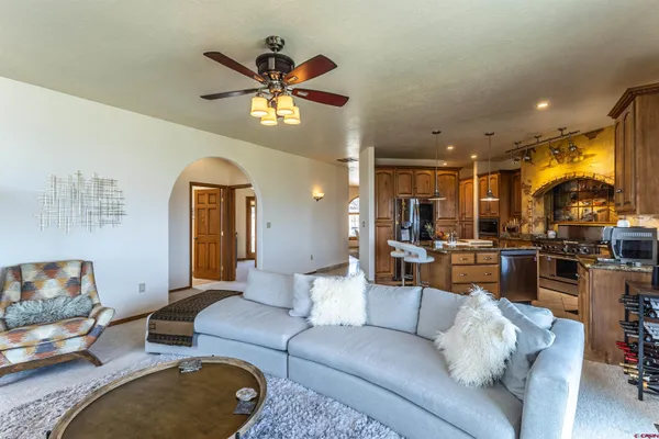 a living room with furniture and a chandelier