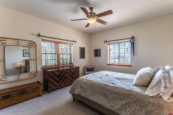 a bedroom with a large bed and a large window