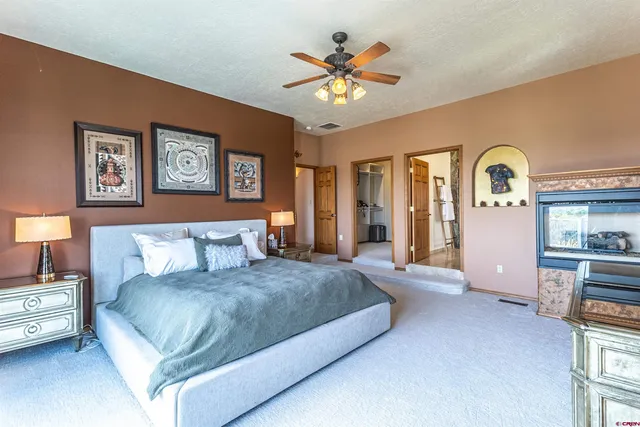 a bedroom with a large bed and a chandelier