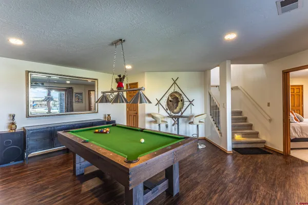 a room with musical instruments pool table and windows