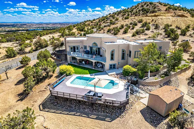 a view of a swimming pool with furniture