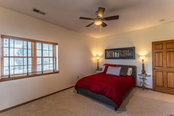 a bedroom with a large bed and a window