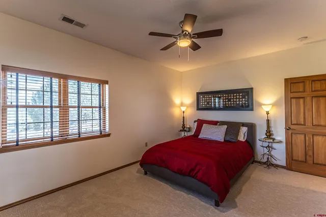 a bedroom with a large bed and a window