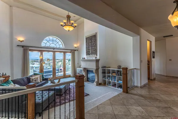 a view of a livingroom with furniture chandelier and wooden floor