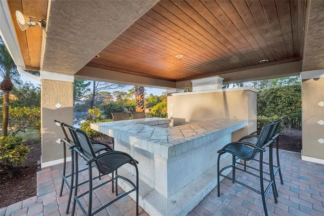 a view of an outdoor dining space with a table and chairs