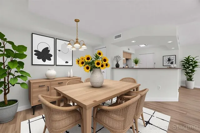 a dining room with furniture and potted plant
