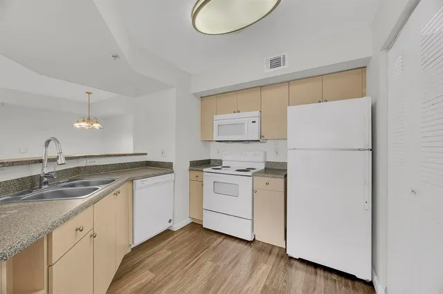 a kitchen with a sink cabinets and stainless steel appliances
