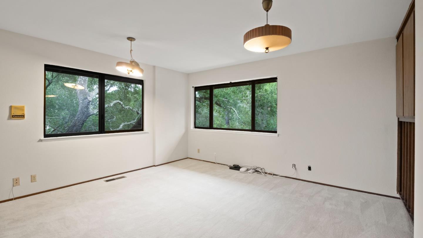 16353 Aztec Ridge Drive Los Gatos, CA 95030 - Photo 37 of 61 a view of an empty room with wooden floor and windows