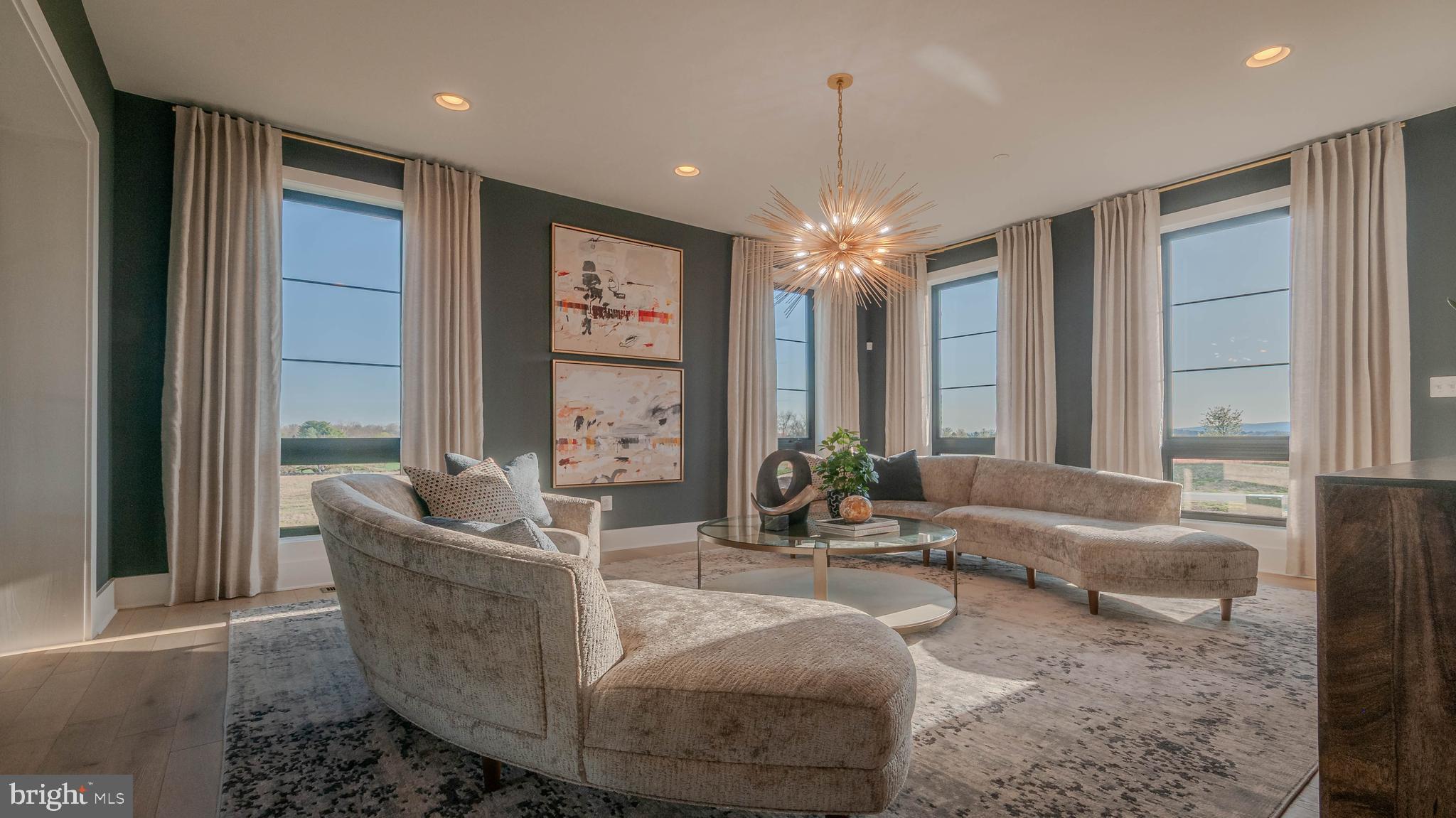 3 Springbury Drive Purcellville, VA 20132 - Photo 4 of 4 a living room with furniture and a chandelier