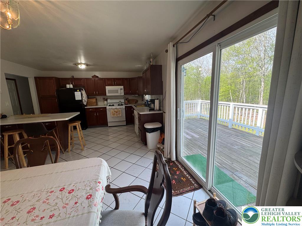 1240 Howeytown Road East Stroudsburg, PA 18302 - Photo 3 of 12 a dining room with furniture and a floor to ceiling window
