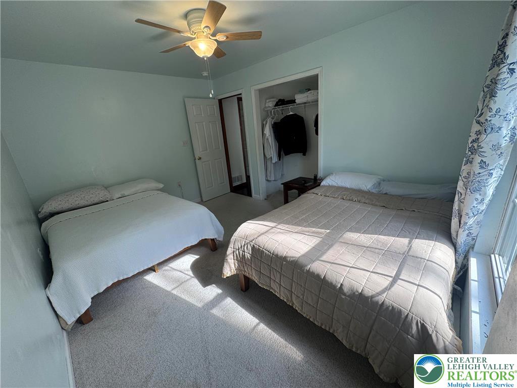 1240 Howeytown Road East Stroudsburg, PA 18302 - Photo 8 of 12 a bedroom with two beds and a chandelier