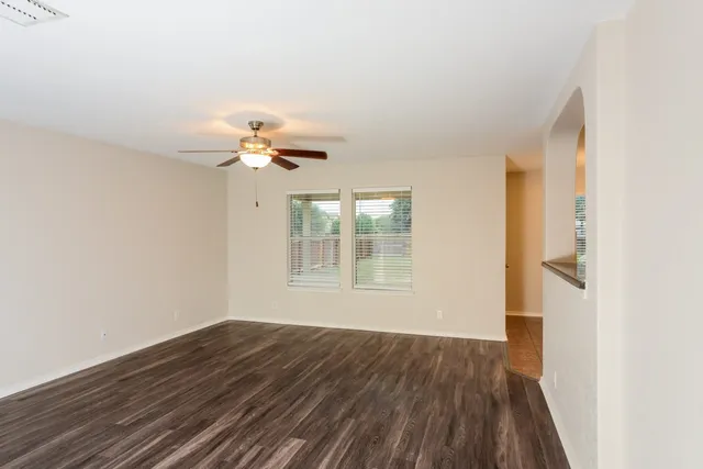 wooden floor in an empty room with a window