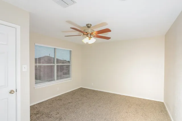 a view of an empty room with a window