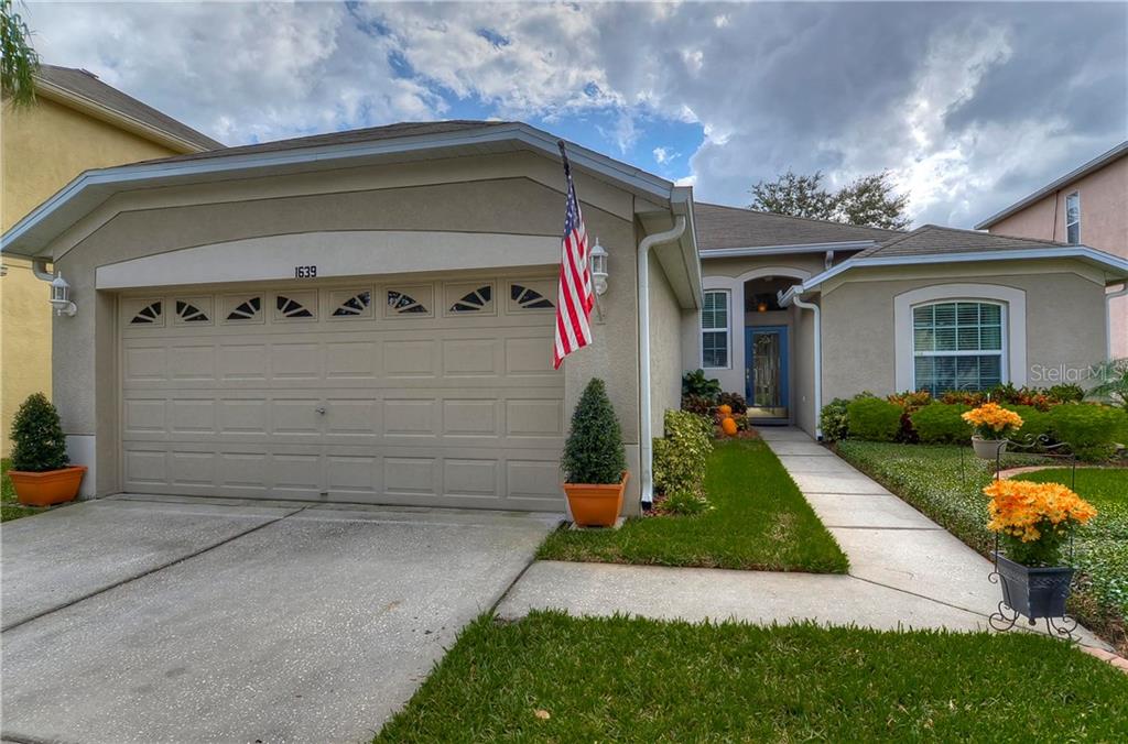 1639 Open Field Loop Brandon, FL 33510 - Photo 1 of 1 a front view of a house with a yard