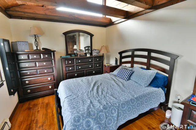 a living room with furniture a window and a wooden floor