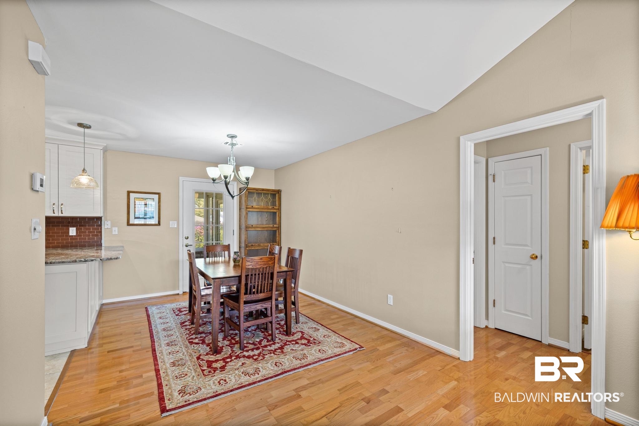 2881 Eslava Circle Lillian, AL 36549 - Photo 7 of 58 Dining area with light wood-style flooring, suspended lighting, and lofted ceiling