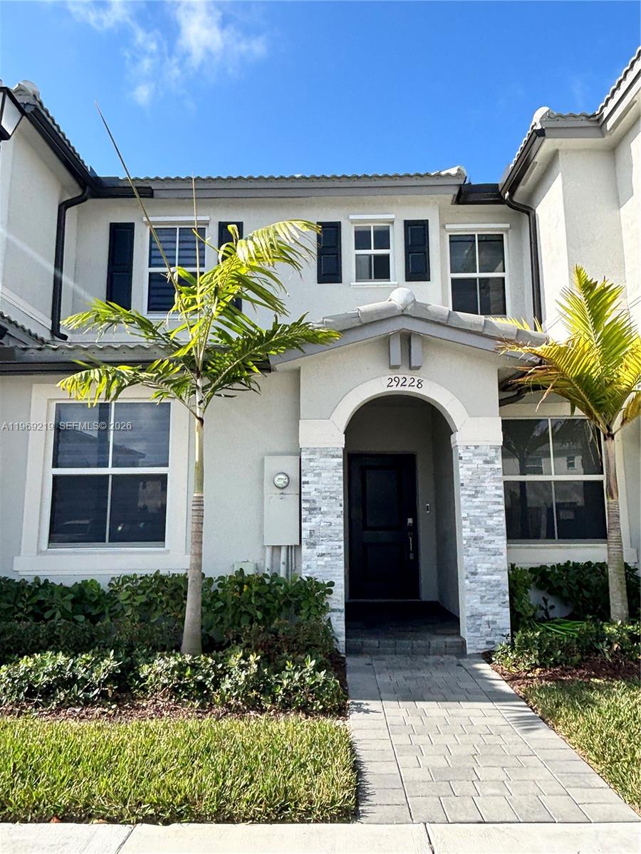 29228 Southwest 163rd Court Homestead, FL 33033 - Photo 1 of 18 a front view of a house with garden