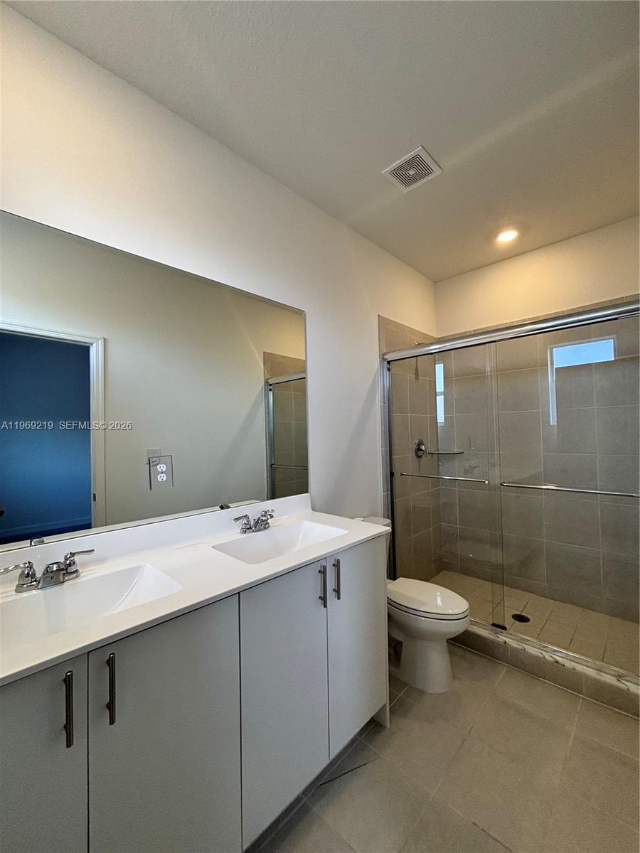 29228 Southwest 163rd Court Homestead, FL 33033 - Photo 13 of 18 a bathroom with a sink a toilet and shower