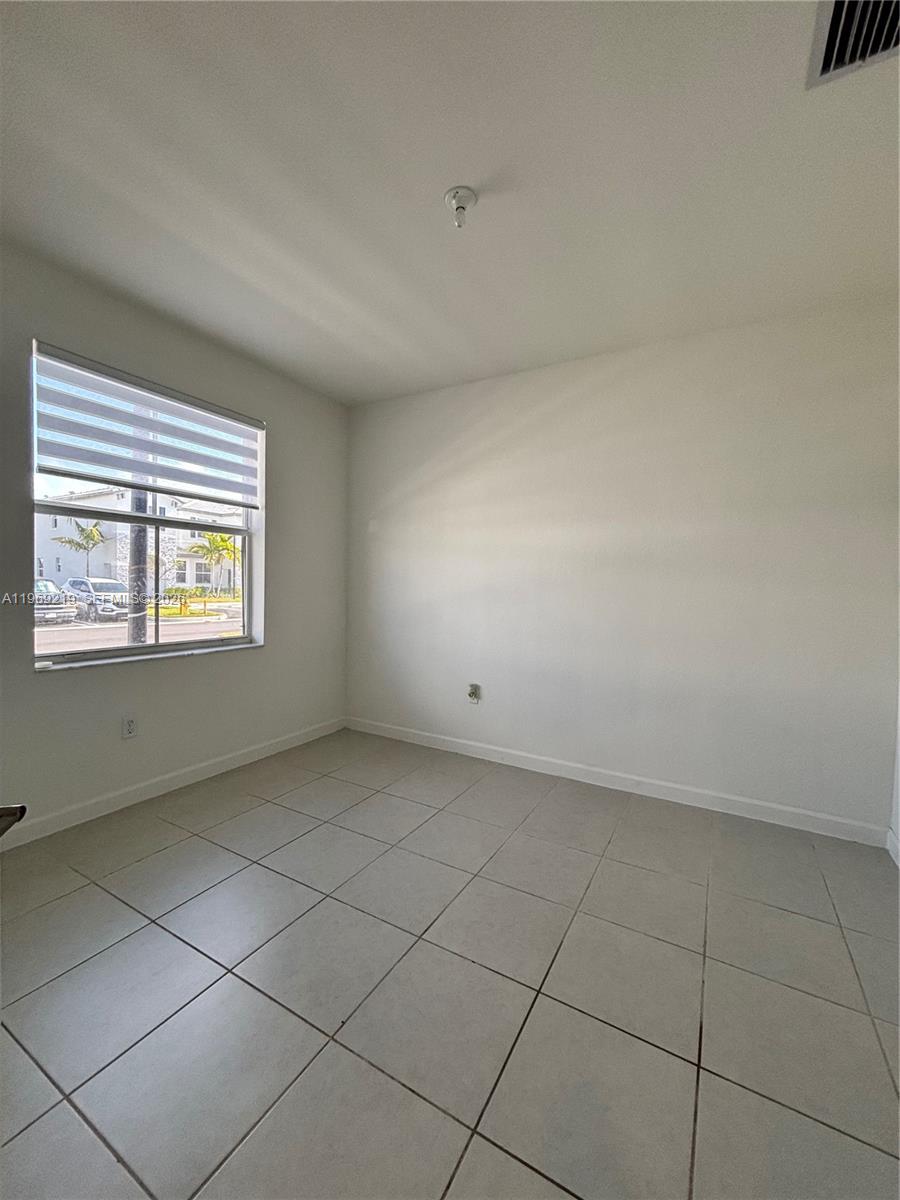 29228 Southwest 163rd Court Homestead, FL 33033 - Photo 8 of 18 an empty room with windows