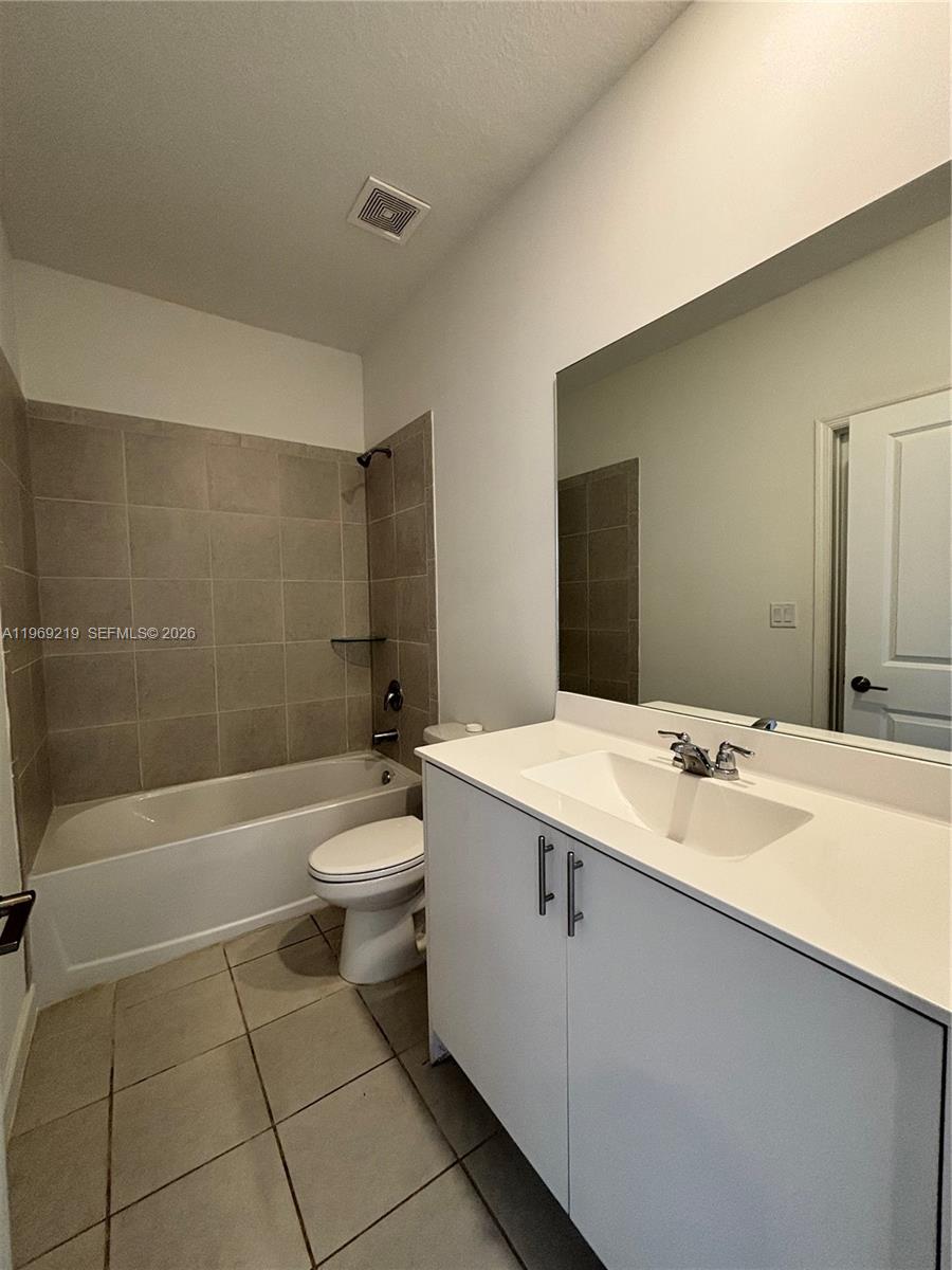 29228 Southwest 163rd Court Homestead, FL 33033 - Photo 9 of 18 a bathroom with a granite countertop sink toilet mirror and bathtub