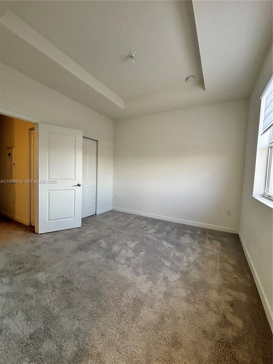 29228 Southwest 163rd Court Homestead, FL 33033 - Photo 10 of 18 an empty room with windows and closet