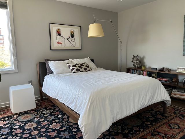 a bedroom with a large bed and a desk