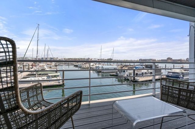 a living room with furniture a fireplace and kitchen view