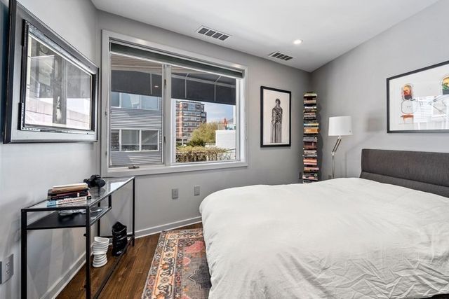 a living room with furniture a rug and a flat screen tv