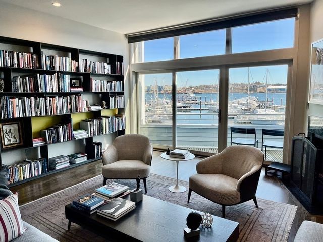 a view of a lake with boats and trees in the background