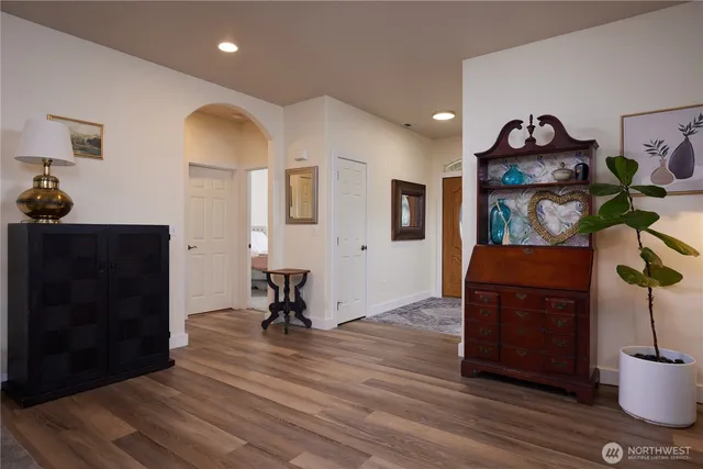 a living room with furniture and a view of kitchen