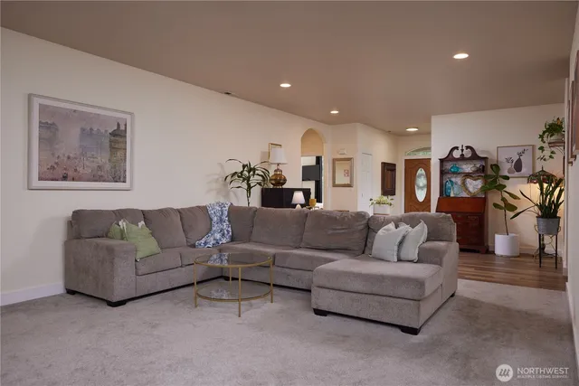 a kitchen with a dining table chairs refrigerator and microwave