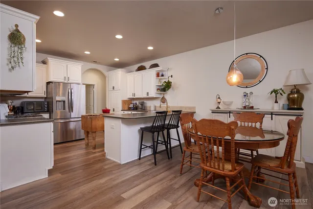 a kitchen with granite countertop a sink stainless steel appliances and cabinets