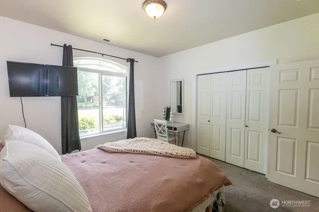 a view of a backyard with table and chairs and a large tree