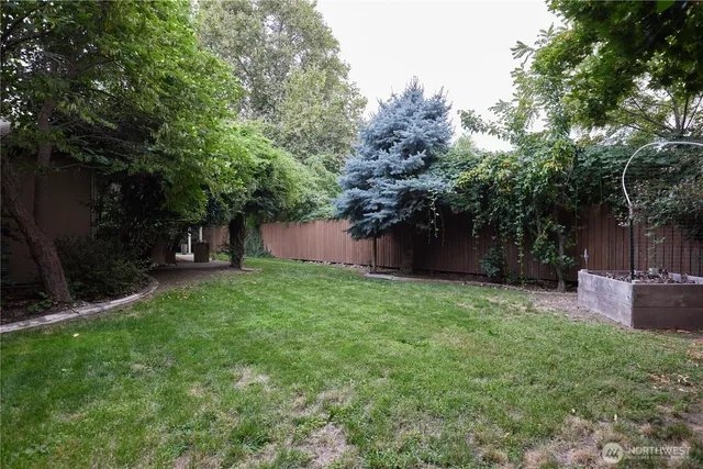 a view of a house with a yard and potted plants