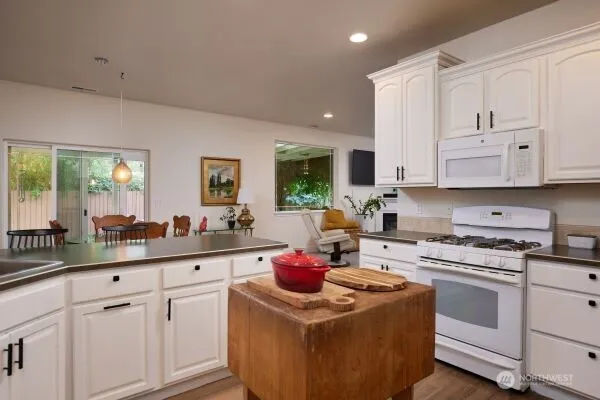 a kitchen with white cabinets and white appliances