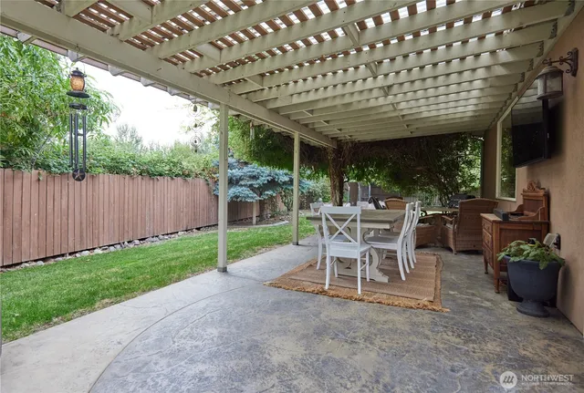 a patio with a table and chairs