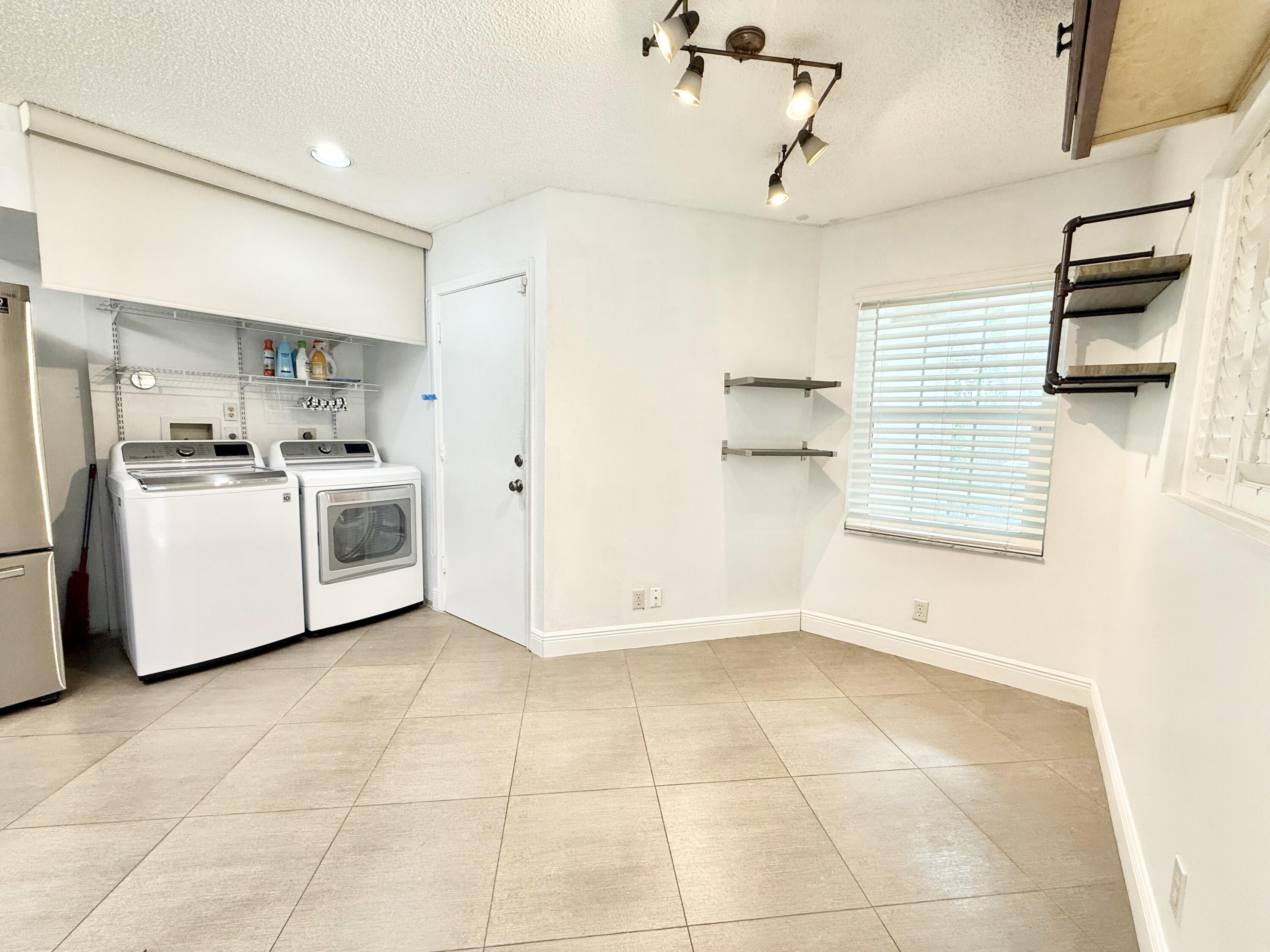 9190 Boca Gardens Parkway, Unit B Boca Raton, FL 33496 - Photo 16 of 35 a view of a kitchen with cabinets and stainless steel appliances