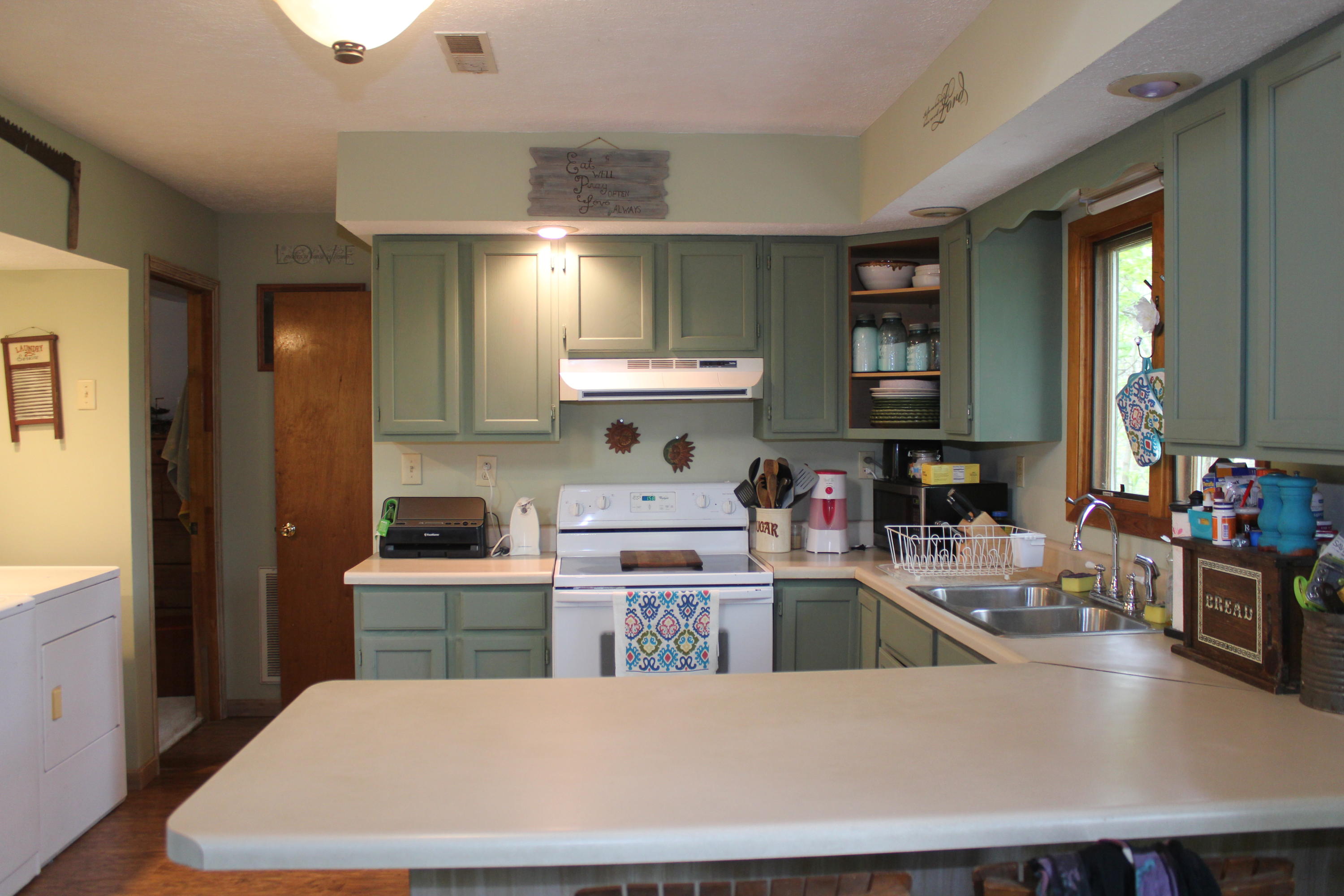 108 Slusher Store Road Northeast Floyd, VA 24091 - Photo 3 of 21 a kitchen with a stove a sink dishwasher and a refrigerator with wooden floor
