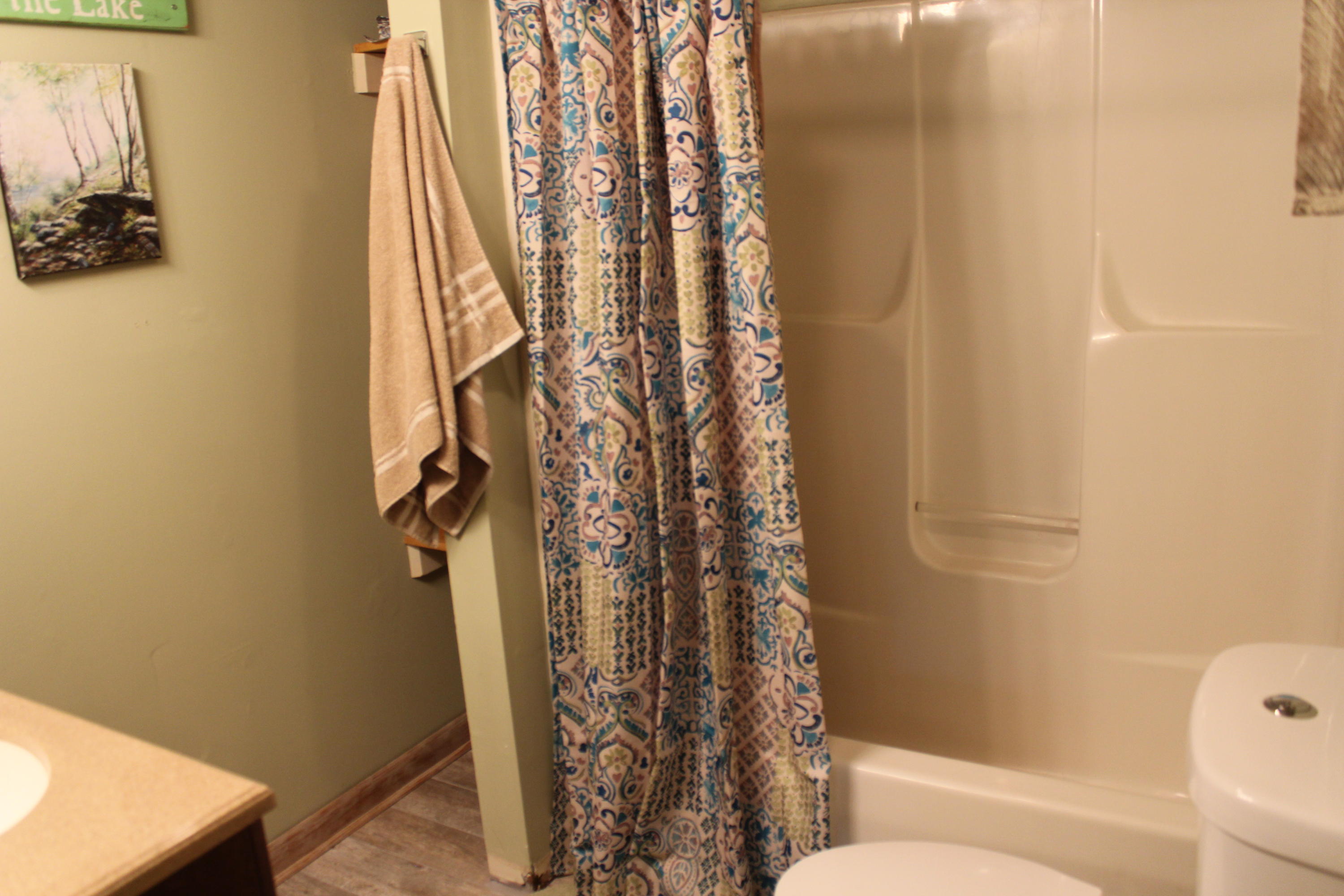 108 Slusher Store Road Northeast Floyd, VA 24091 - Photo 9 of 21 a bathroom with a toilet and shower curtain