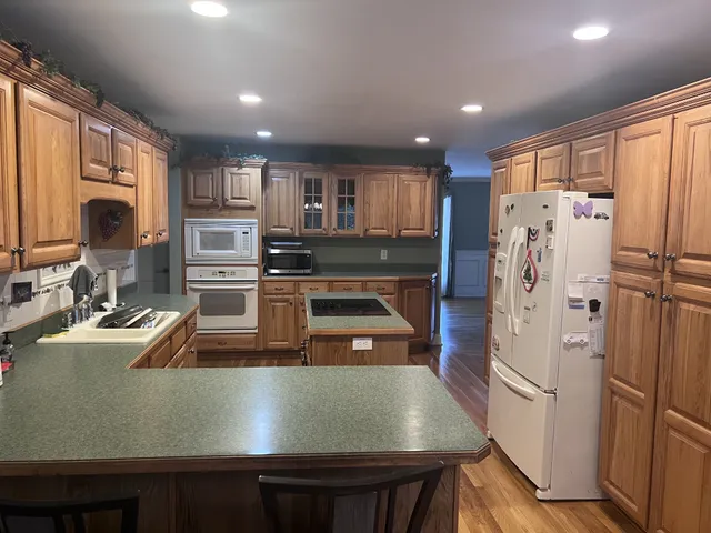 a bathroom with a tub a double vanity sink and mirror